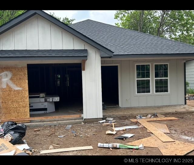 view of front of property featuring roof with shingles and board and batten siding
