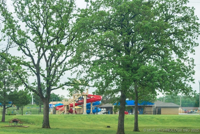 view of jungle gym with fence and a yard