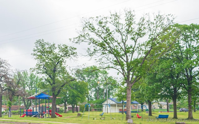 view of community featuring a yard and playground community