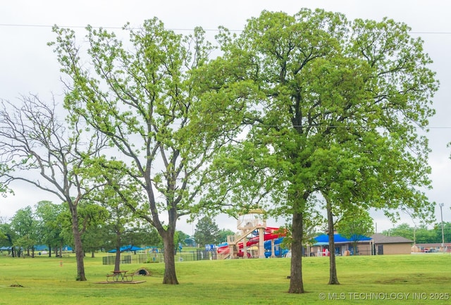 view of home's community featuring a lawn and fence