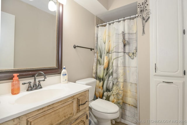 full bathroom with vanity, toilet, and curtained shower