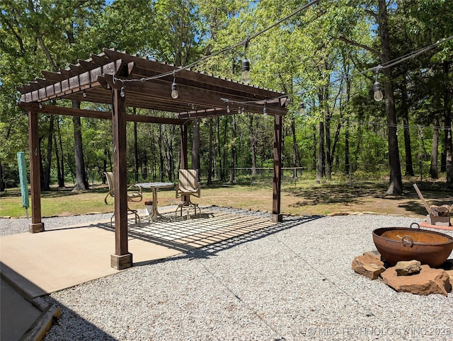 277 Oak Hollow Rd, Eufaula, OK 74432 - view of patio / terrace with a pergola, fence, and a fire pit
