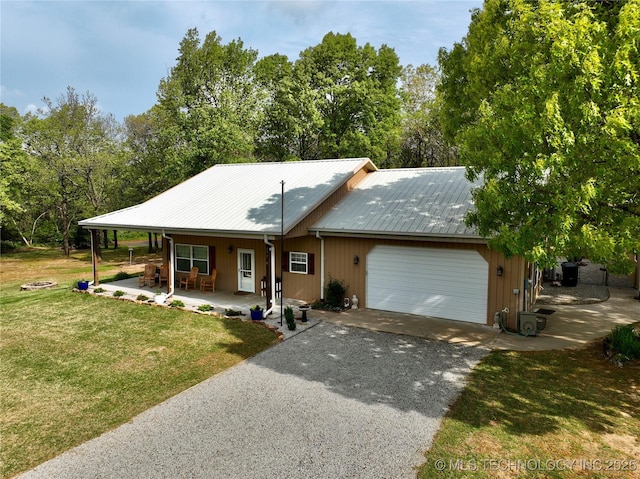 277 Oak Hollow Rd, Eufaula, OK 74432 - view of front of property featuring a garage, a front yard, covered porch, asphalt driveway, and metal roof