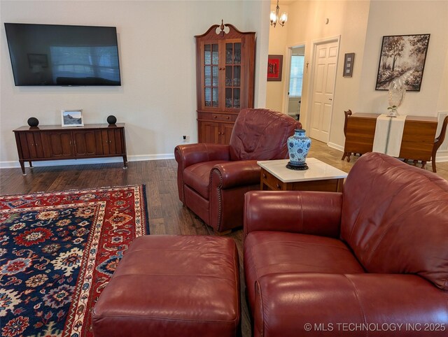 277 Oak Hollow Rd, Eufaula, OK 74432 - living room featuring baseboards, wood finished floors, and a chandelier