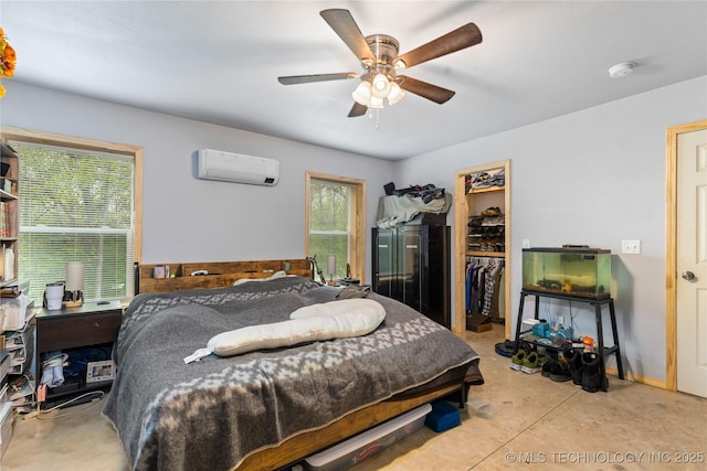 65365 E 155th Rd, Wyandotte, OK 74370 - bedroom featuring ceiling fan, a closet, concrete flooring, an AC wall unit, and a spacious closet