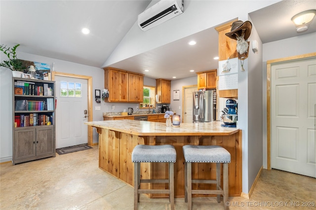 65365 E 155th Rd, Wyandotte, OK 74370 - kitchen with a wall mounted AC, a breakfast bar, a peninsula, light countertops, and appliances with stainless steel finishes
