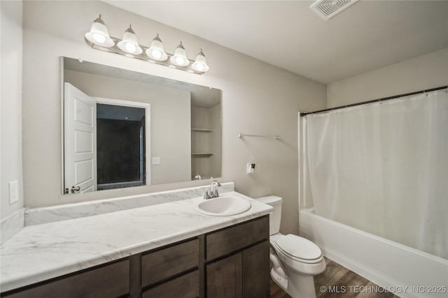 bathroom with shower / bath combo, vanity, toilet, visible vents, and wood finished floors