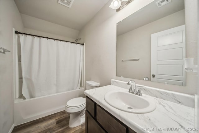 full bath featuring toilet, visible vents, shower / tub combo, and wood finished floors