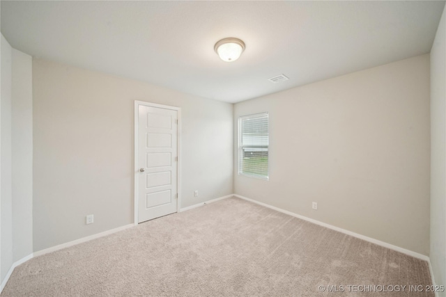 empty room featuring baseboards and carpet flooring