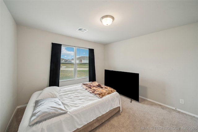 carpeted bedroom with visible vents and baseboards