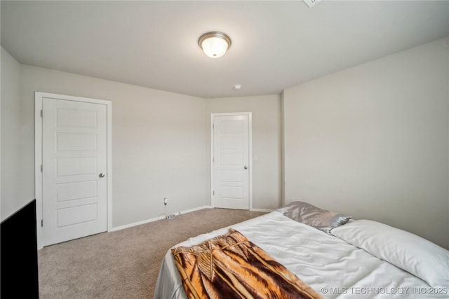 carpeted bedroom with baseboards