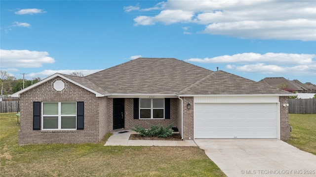 ranch-style home with roof with shingles, an attached garage, brick siding, and a front yard