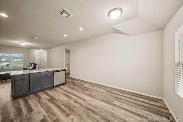 kitchen with wood finished floors, visible vents, dishwasher, and a sink