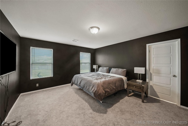 bedroom with visible vents, carpet, and baseboards