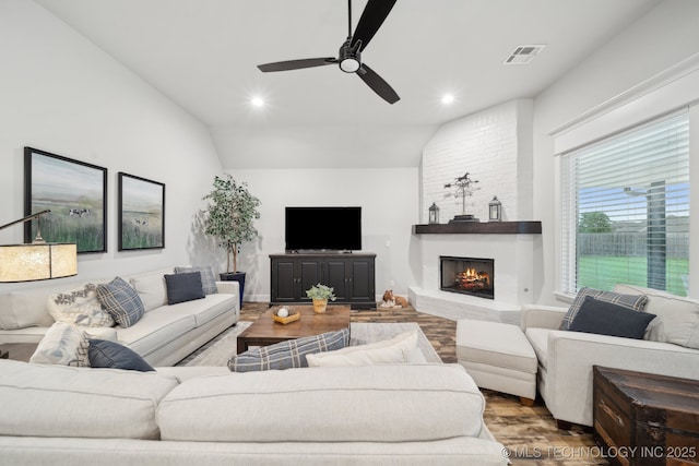 1992 E 173rd St S, Mounds, OK 74047 - living room featuring ceiling fan, visible vents, a fireplace, wood finished floors, and lofted ceiling