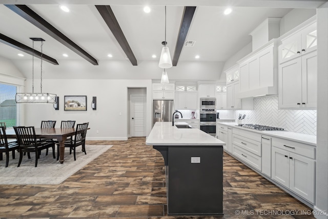 1992 E 173rd St S, Mounds, OK 74047 - kitchen featuring appliances with stainless steel finishes, dark wood-style floors, light countertops, backsplash, and a center island with sink