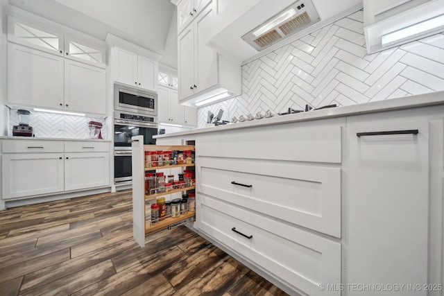 1992 E 173rd St S, Mounds, OK 74047 - kitchen featuring appliances with stainless steel finishes, tasteful backsplash, light countertops, glass insert cabinets, and white cabinetry