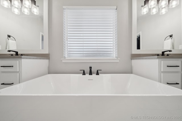 1992 E 173rd St S, Mounds, OK 74047 - bathroom featuring a freestanding tub, an inviting chandelier, and vanity