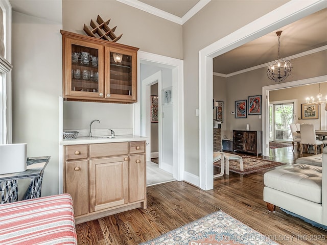 1805 W Easton St, Tulsa, OK 74127 - bar featuring a chandelier, dark wood finished floors, ornamental molding, and hanging light fixtures