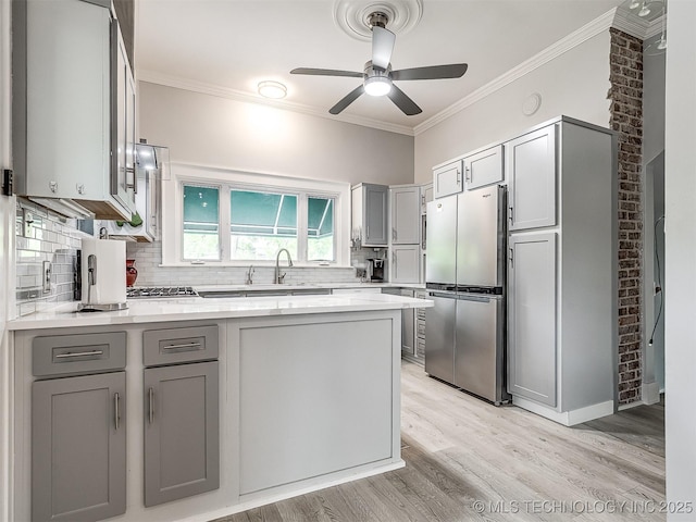1805 W Easton St, Tulsa, OK 74127 - kitchen featuring freestanding refrigerator, gray cabinetry, a peninsula, light wood-type flooring, and ornamental molding