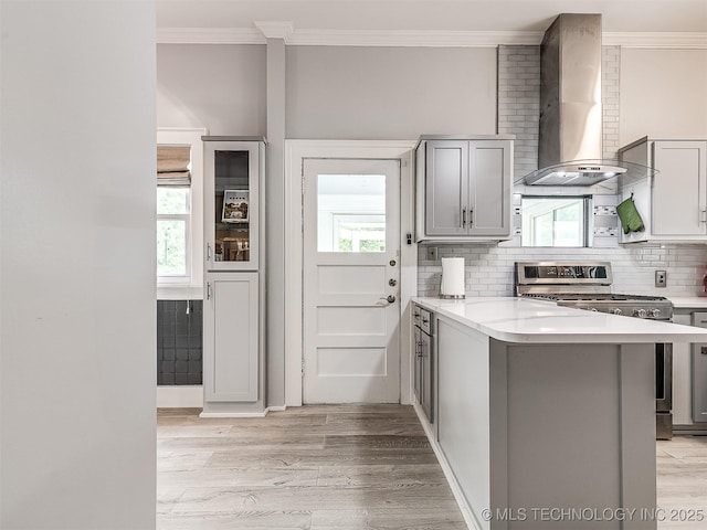 1805 W Easton St, Tulsa, OK 74127 - kitchen with wall chimney range hood, stainless steel gas range oven, gray cabinetry, ornamental molding, and backsplash