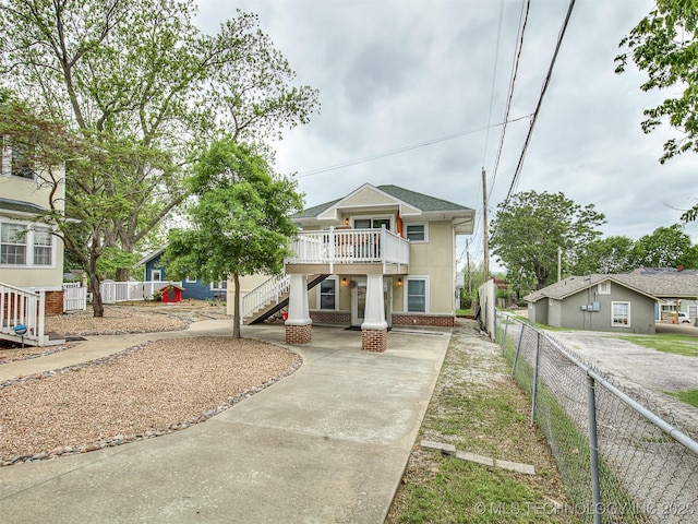 1805 W Easton St, Tulsa, OK 74127 - view of front of home with stairs, driveway, stucco siding, and a wooden deck