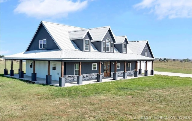 view of front of property with a front lawn, metal roof, and a porch
