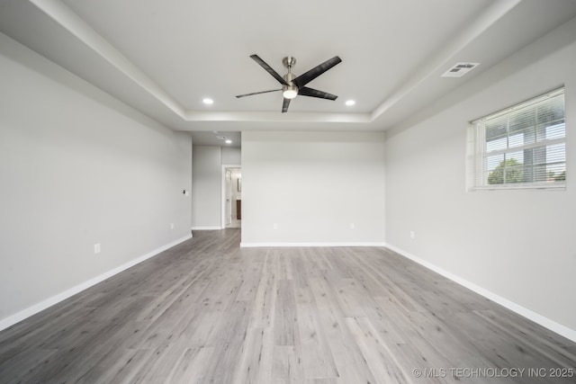 spare room featuring a raised ceiling, a ceiling fan, recessed lighting, and visible vents