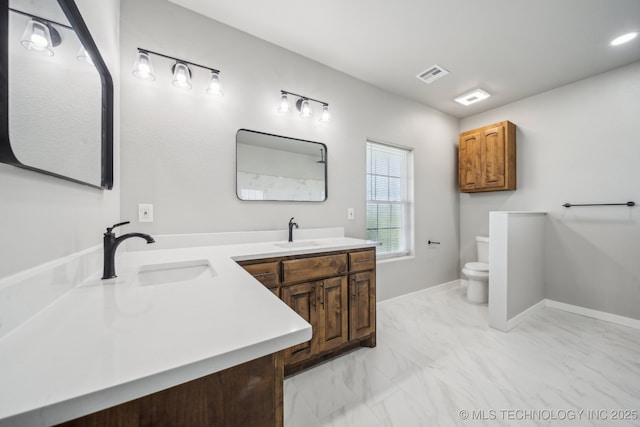 full bath featuring a sink, toilet, marble finish floor, and visible vents