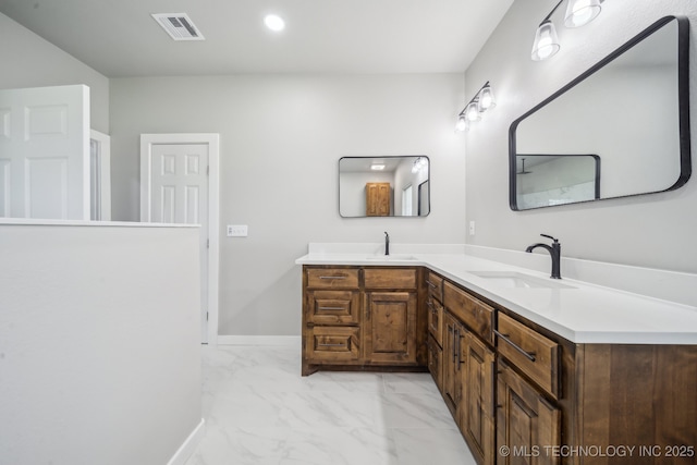 bathroom with a sink, marble finish floor, double vanity, and visible vents