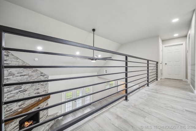 stairs with ceiling fan, recessed lighting, baseboards, wood finished floors, and lofted ceiling