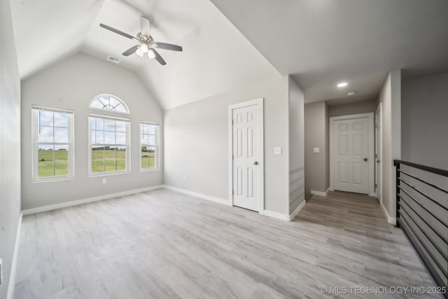 unfurnished living room with ceiling fan, light wood-style flooring, baseboards, lofted ceiling, and visible vents