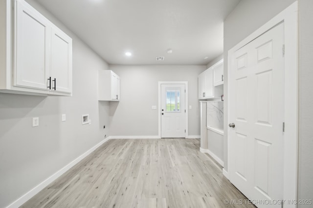 clothes washing area with cabinet space, washer hookup, hookup for an electric dryer, light wood-type flooring, and recessed lighting