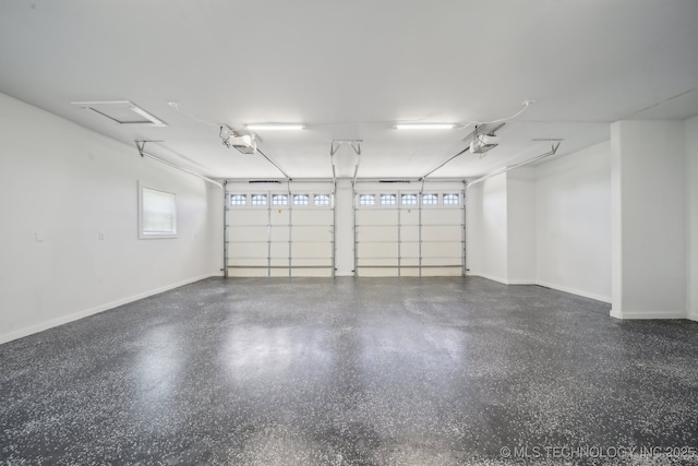 garage featuring a garage door opener and baseboards
