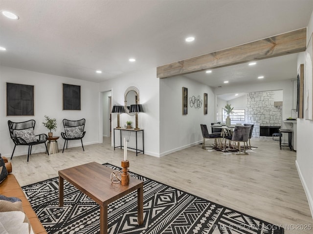 living room featuring baseboards, recessed lighting, wood finished floors, and beam ceiling