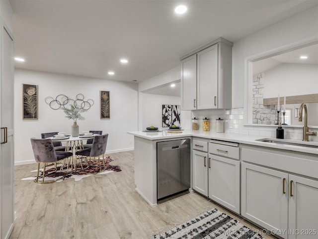 kitchen with backsplash, stainless steel dishwasher, recessed lighting, and a sink