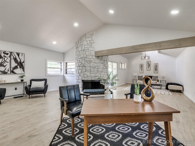 office area featuring a fireplace, light wood-type flooring, plenty of natural light, and baseboards