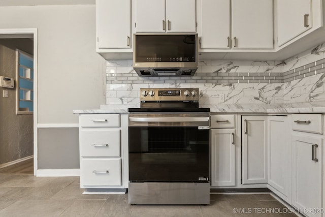 kitchen with baseboards, white cabinets, tasteful backsplash, and stainless steel appliances