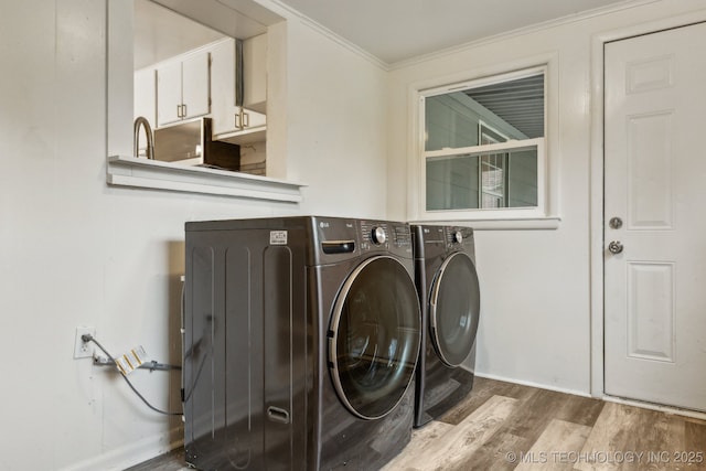 laundry room with laundry area, crown molding, washing machine and dryer, wood finished floors, and baseboards