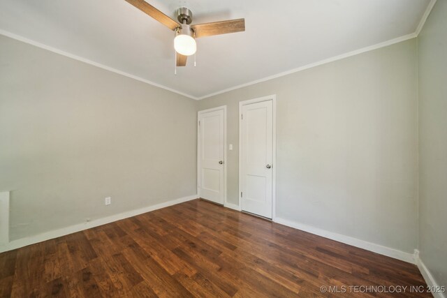 empty room with baseboards, ornamental molding, and wood finished floors
