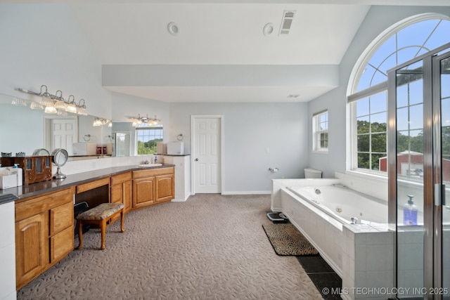 full bathroom featuring a tub with jets, a healthy amount of sunlight, visible vents, and baseboards