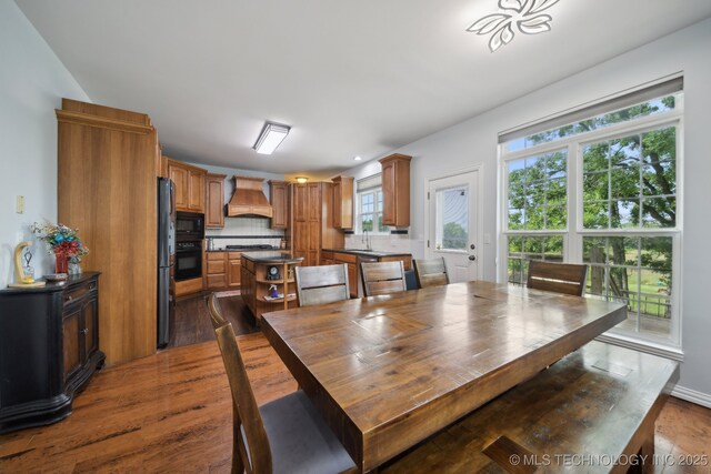 dining space with dark wood finished floors