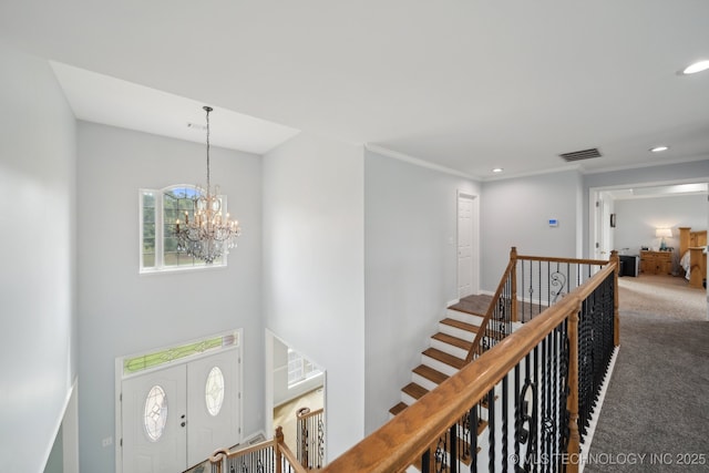 interior space featuring carpet, visible vents, recessed lighting, and a notable chandelier