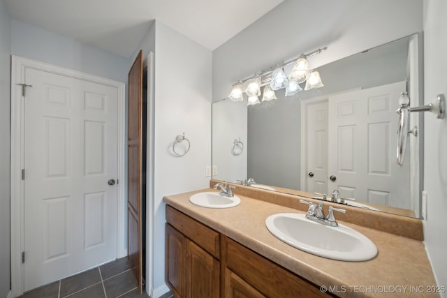 full bath with tile patterned floors, double vanity, and a sink