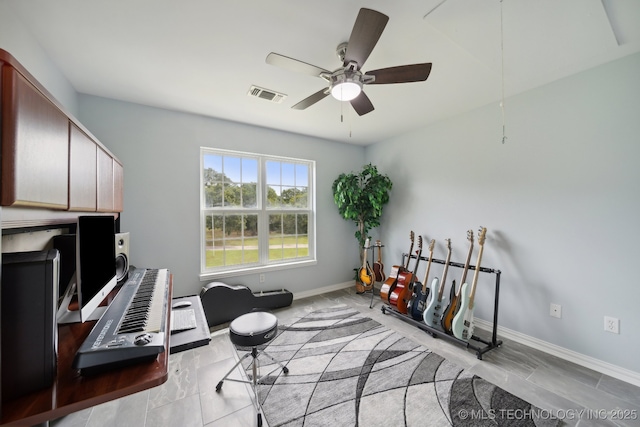 interior space featuring baseboards, visible vents, and a ceiling fan