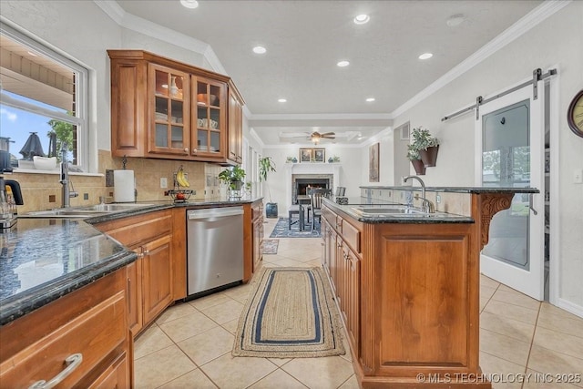 kitchen with dishwasher, ceiling fan, tasteful backsplash, a sink, and light tile patterned floors