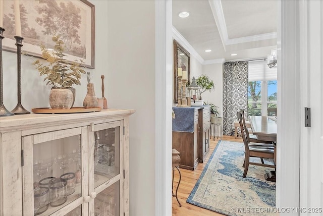 hall with crown molding, recessed lighting, and light wood finished floors