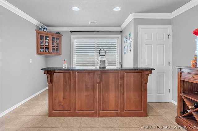 bar with baseboards, ornamental molding, bar, and visible vents