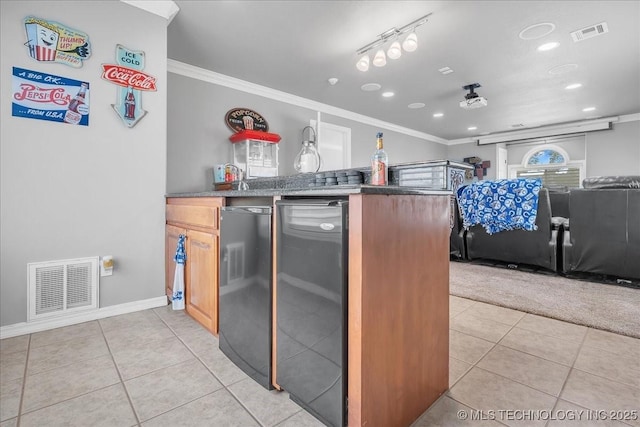 kitchen with visible vents, ornamental molding, dark countertops, baseboards, and light tile patterned floors