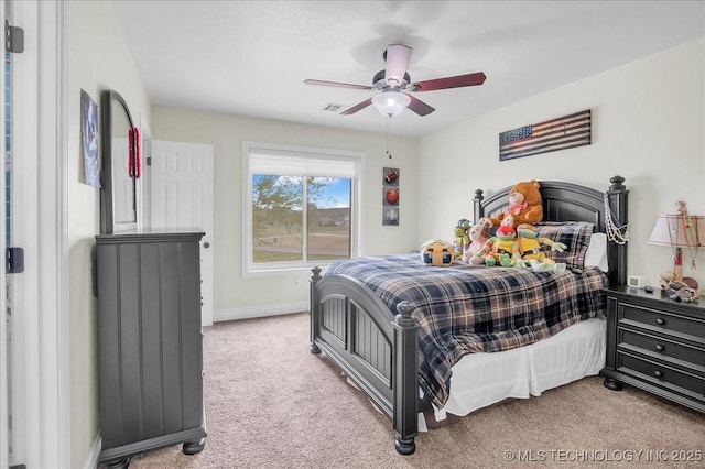 carpeted bedroom with a ceiling fan, baseboards, and visible vents
